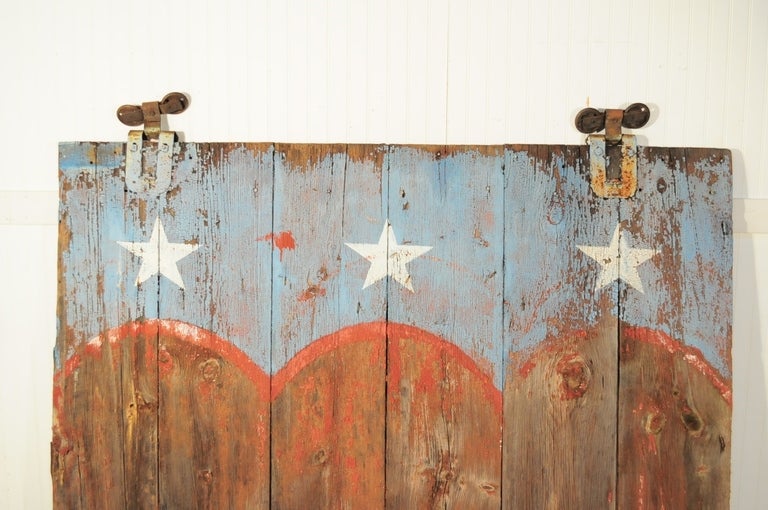 Stunning Antique 19th Century Authentic Bucks County Pennsylvania Farm Barn Door with cast iron rolling hinges. This fine piece of american history features beautifully distressed red white and blue american flag paint. The wood doors are handmade