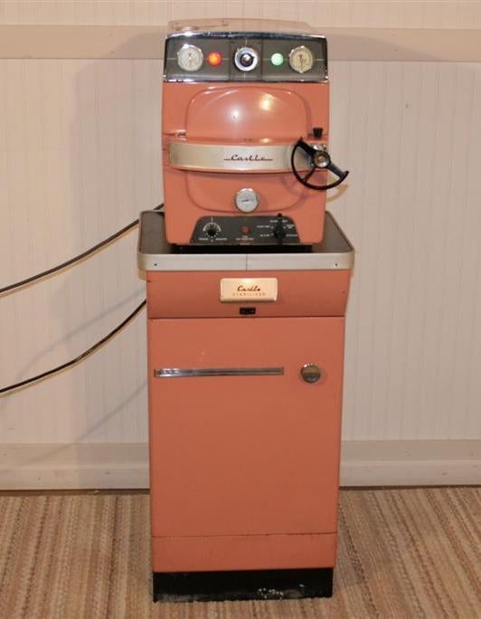 Very Cool Nostalgic 1950's Original Salmon Pink Wilmot Castle Autoclave Sterilizer on Original One door lighted stand with inside tray. Sterilizer does come on and appears to be in working condition. Price includes Sterilizer and Stand