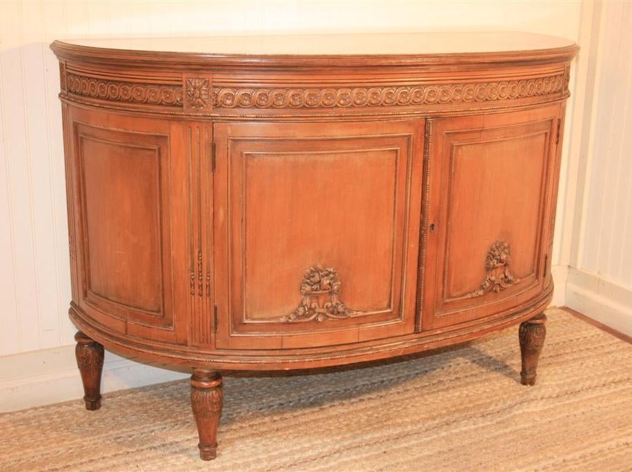 Remarkable Half Round French Demilune by Aimone Mfg of New York in an authentic and desirable lighly distressed/white washed shabby chic finish. Item features detailed floral carvings, carved feet, great half round form, and substantial size.