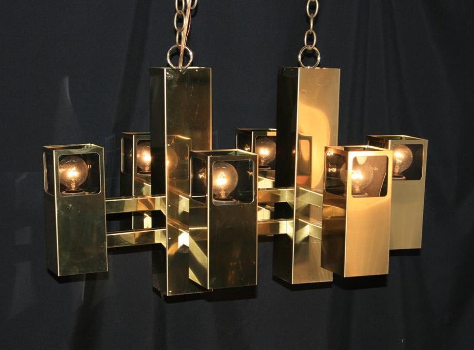 Very Unique Mid Century Modern Brass Cubist Chandelier having 14 lights in total. There are six upward facing lights and eight downward facing lights. This rare chandelier has three different light settings allowing you to adjust the illumination of