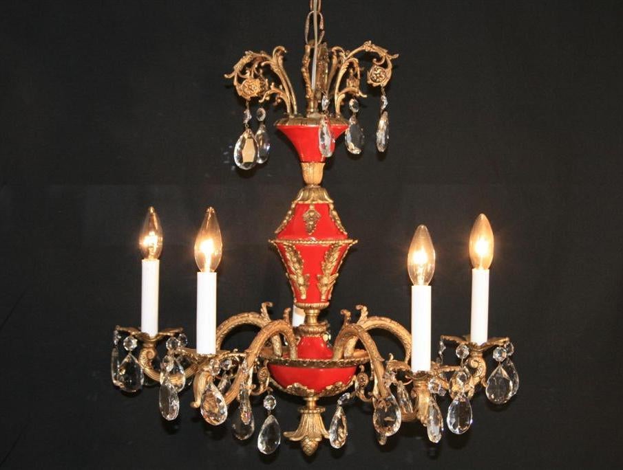 Very Beautiful French Empire Style 5 light Brass and Clear Crystal Chandelier dating back to around the 1940's. Item features wonderfully engraved brass details including the headdress, whimsical curvaceous arms, pineapple bottom, and glamorous red