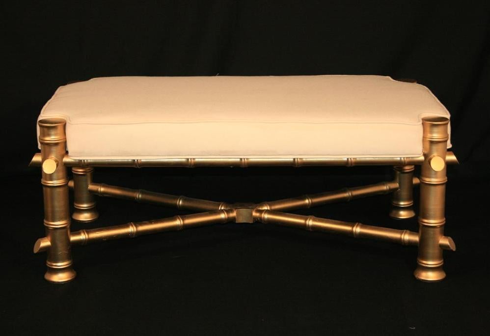 Vintage Hollywood Regency / Chinese Chippendale faux bamboo window bench. This bench is made of solid wood and is finished in metallic gold. Item features a unique X-form stretcher base and exposed posts at each corner. Seat has brand new foam and