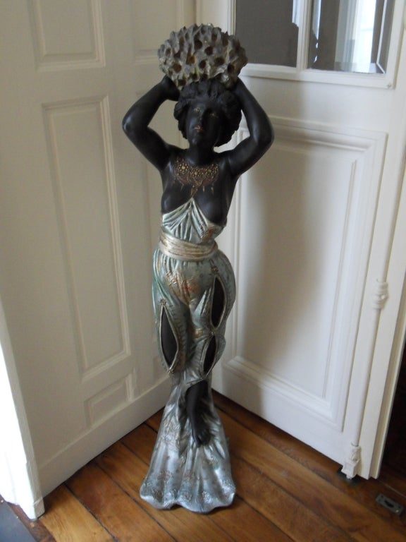 A large  circa 1900's art nouveau sculture in silvered and gilt finely sculpted wood,representing a mermaid  carrying a coral.