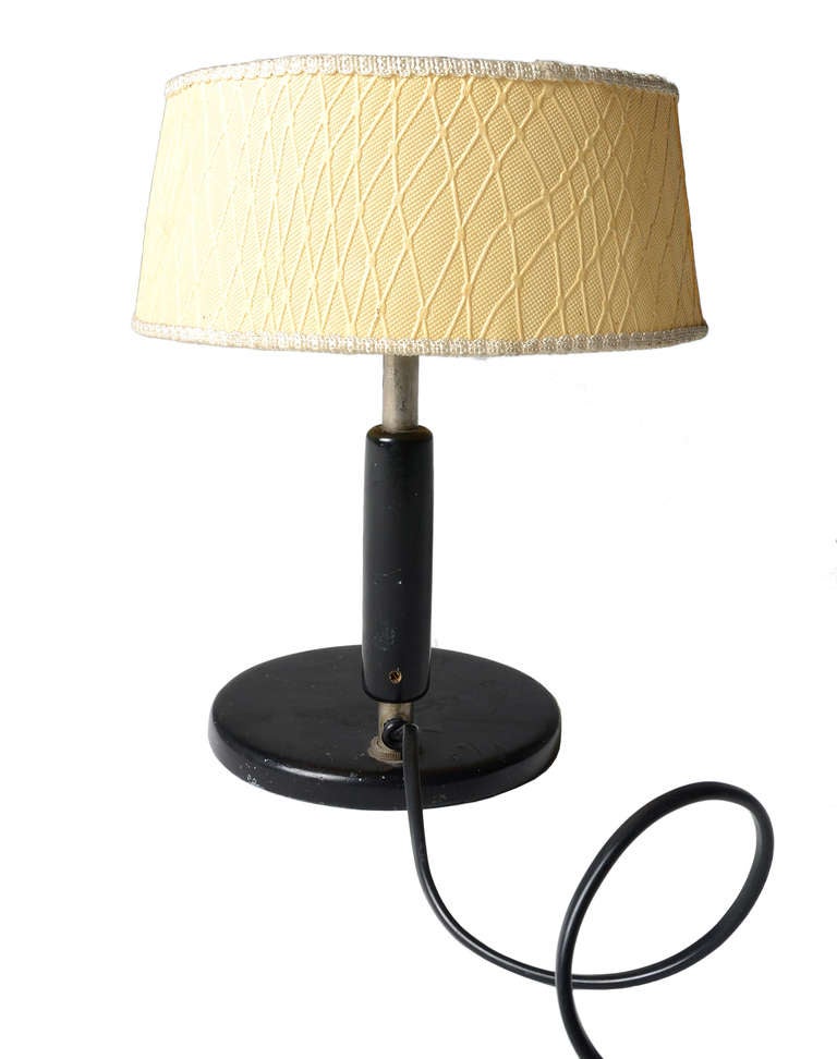 A super early Paavo Tynell table lamp for Taito Oy from 1935.
This is marked as Model 5053 in the 1935 Taito Catalogue. A similar example has a glass shade.

This example with a cast iron base and nickelled central column with a wood insert.
The