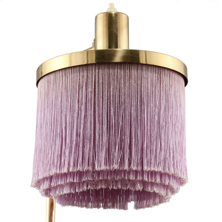 A pretty little Hans Agne Jakobsson table lamp in brass.
Elegant fringe shade with enamelled metal diffusion core for balanced light.