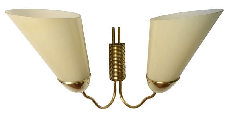 A monumental wall sconce by Paavo Tynell contemporary and workmate Mauri Almari for Taito Oy.
These sconces were designed by Almari and Tynell in the 1940's.  The beginning of the Scandinavian Modern era.
Incredibly made with solid brass