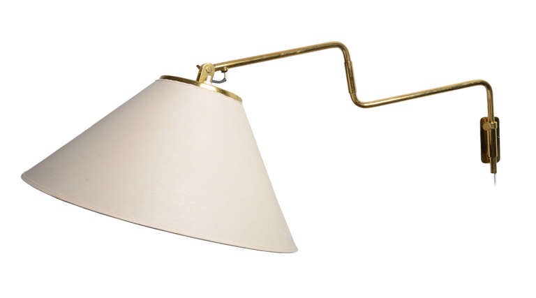 A very special pair of articulated wall lamps by Paavo Tynell for Taito Oy.

Solid brass construction .   Very adjustable at the wall mount, the middle joint, and the shade head itself.


