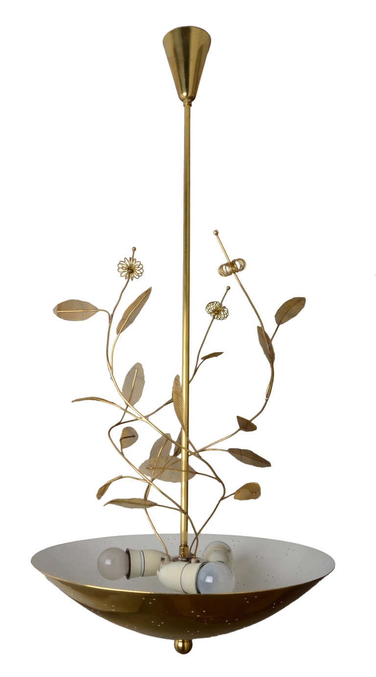 An exceptional and large chandelier by Finnish Lighting Master Paavo Tynell.

This example is incredibly elegant in it's simplicity and execution.

From a large solid brass pierced bowl emerges three long branches with leaves and florets.

A
