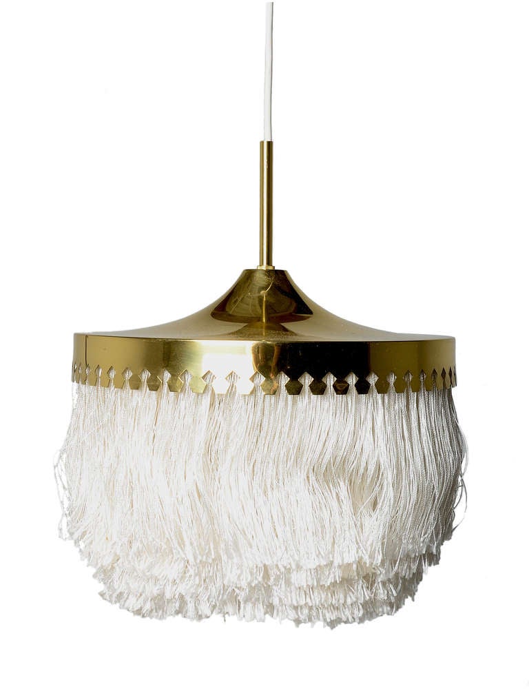 Unusual fringed brass chandeliers designed by Hans Agne Jakobsson, Sweden.

These lamps have a solid brass cut shade and silk fringe/tassles.

Sold separately .  These look amazing as a group.