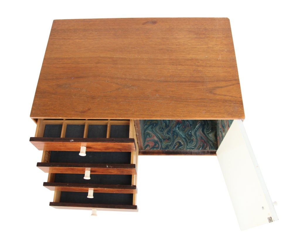 A very nice George Nelson designed jewelry chest for Herman Miller.
4 drawers and one large door .   Stands on tiny rubber feet.  
Original marbleized paper interior.


Note: This item is located in New York for pick up or delivery.