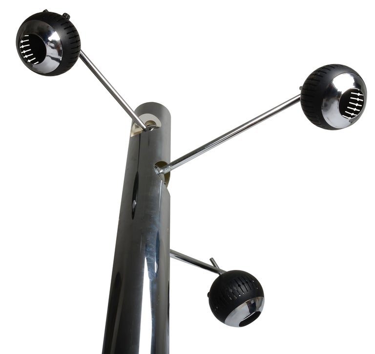 A very impressive and rare large floor lamp by Lelli.
This example is more sculpture than lamp .    Beautiful chromed metal with weighted base and adjustable arms.
