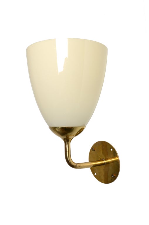 A pair of rare and unusual Paavo Tynell wall sconces in solid brass and thin handblown glass produced exclusively for the  Kontiolahti Church in Finland.  Ca. 1955.
Two pairs availble.  30cm dia. and 45 cm.