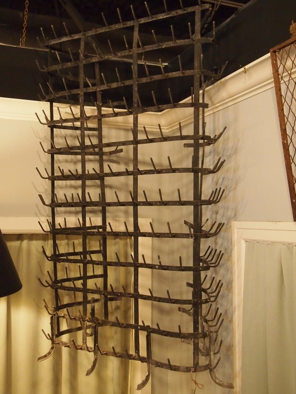 Large French iron wine bottle rack in unusual design. Will stand level on ground