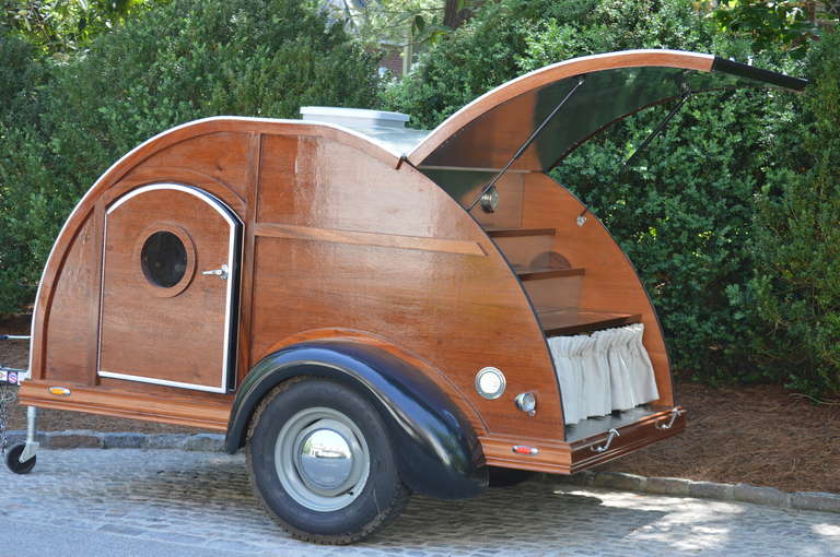 Reproduction Teardrop Party Trailer - the ultimate in tailgating! Hand crafted of Mahogany with the finest details. Interior sleeps two and so light it can be pulled by a mini cooper!

Exterior dimensions 60”w x 96” 
Interior dimensions 58.5”w