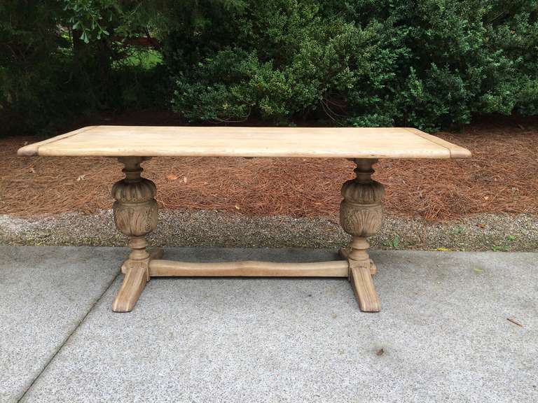 19thc Belgian bleached Oak Dining table with intricately carved trestle. Top has bread board ends. Would also make a great desk. Beautiful Patina.