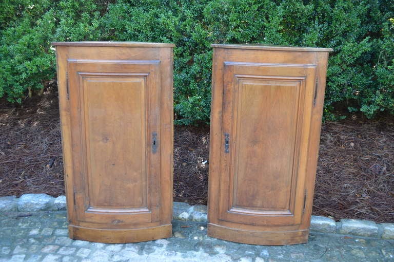 Pair of Hanging French Walnut Corner Cabinets. Original Brass hinges and two interior shelves. Priced separately.