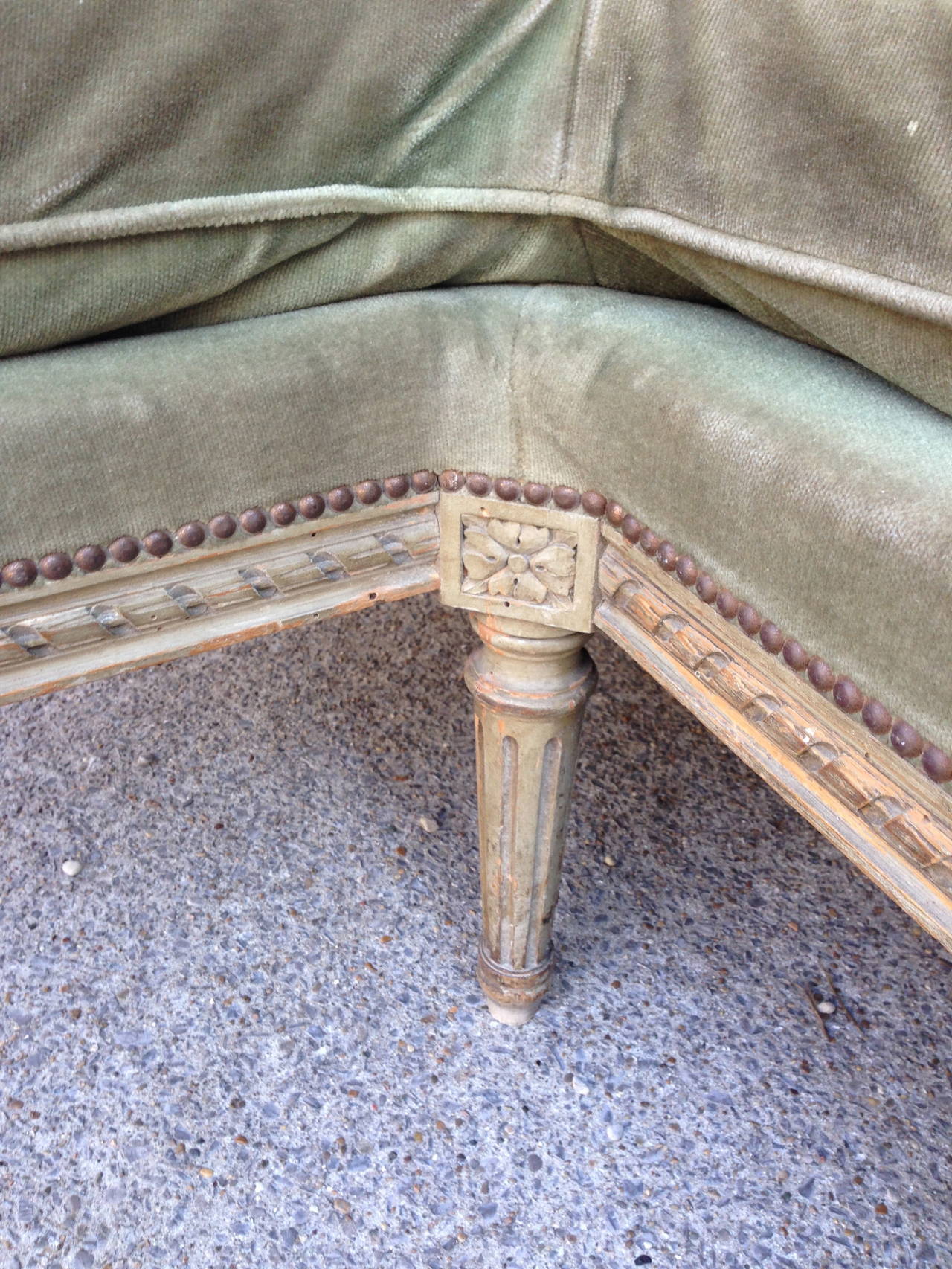 French 19th century Louis XVI settee features exquisitely fine carved rope detail and brass studs. Beautiful original velvet upholstery. Tapered and fluted legs complete the look. Seat cushion depth is 23