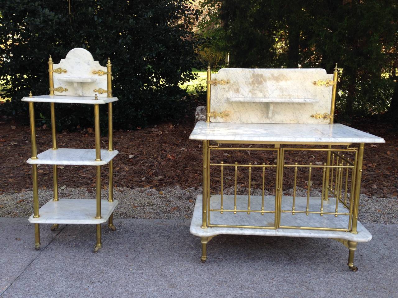 Fabulous pair of French marble and brass carts from Paris. The carts have decorative brass straps and brass casters. The large cart has a working gate below. Would be fabulous as a bar or in a kitchen. Lovely patina on the Carrara marble and aged