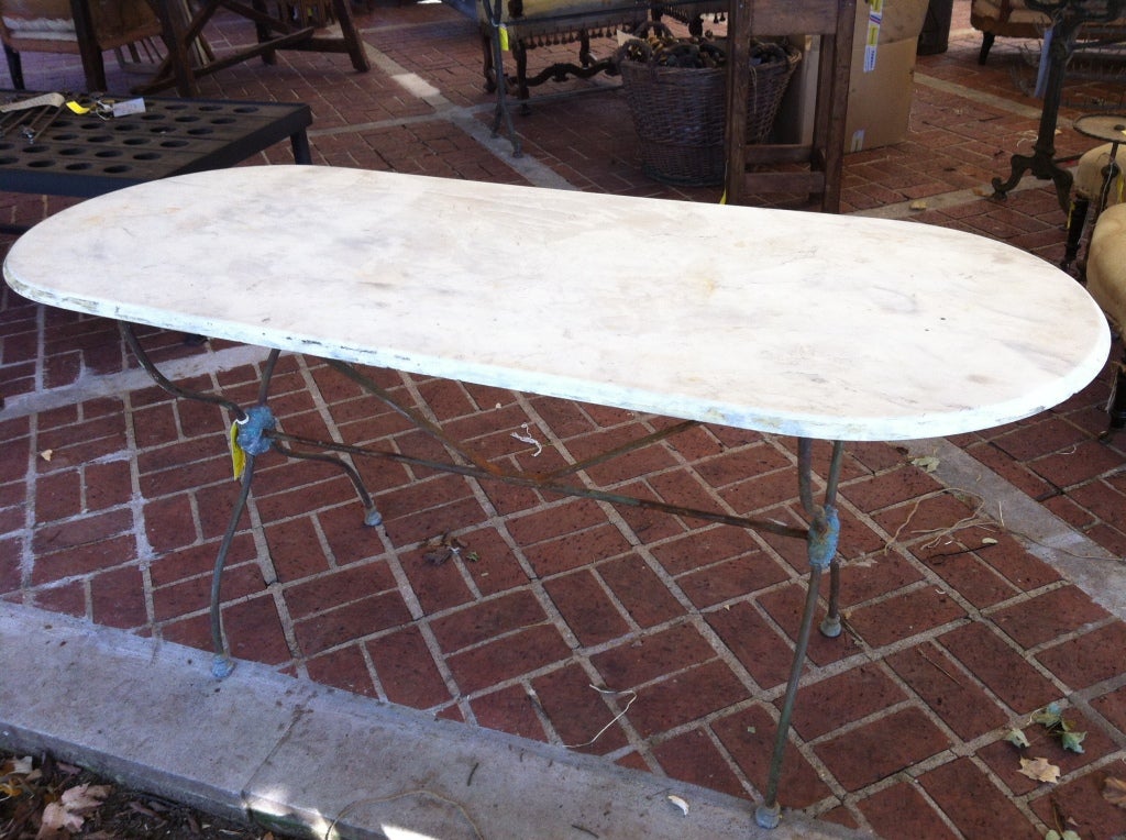 French 19th c Marble top bistro table with iron base. Beautiful patina and unusual beveled oval top