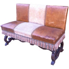 French Leather settee with Carved base and tassel fringe