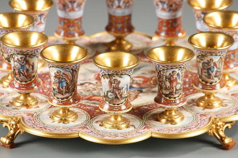 A Vienna enamel silver-gilt plateau and its twelve glasses representing the year
