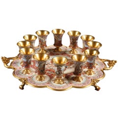 A Vienna enamel silver-gilt plateau and its twelve glasses representing the year