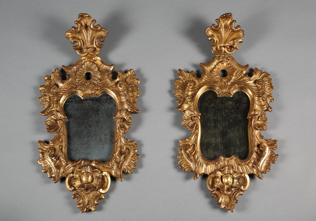 Pair of 18th Century Venetian gilt and sculpted wood mirrors