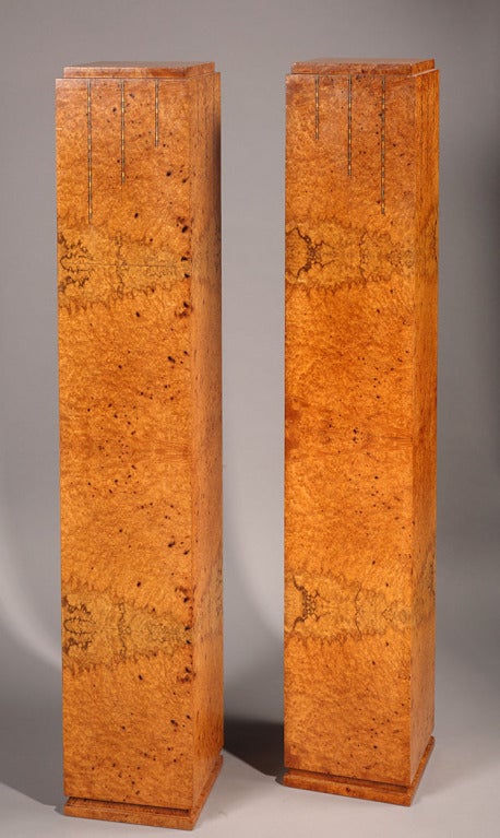 A pair of elm burr stands, of a square shape. The top part is ornamented with vertical lines worked with geometrical patterns.