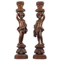 Pair of walnut sculpted figures of putti