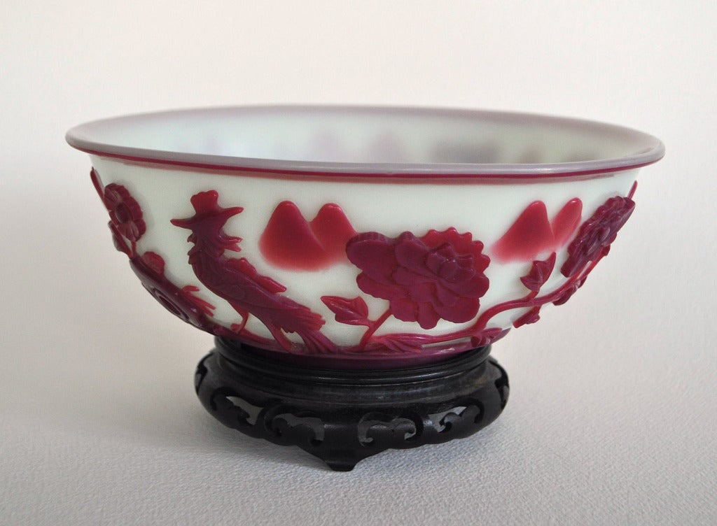 A lovely and finely executed Peking glass bowl with pink flowers, mountains, and birds over white. 3 1/4 inches tall without stand.