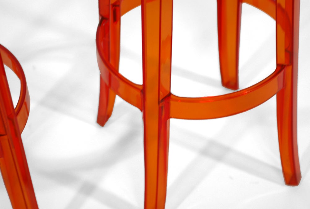 A perfect companion to the Louis and Victoria Ghost chairs, the Charles Ghost stool is a distilled, modern expression of the Louis XIV style rendered in clear orange plastic. The stools are made from is made of scratchproof, shockproof polycarbonate