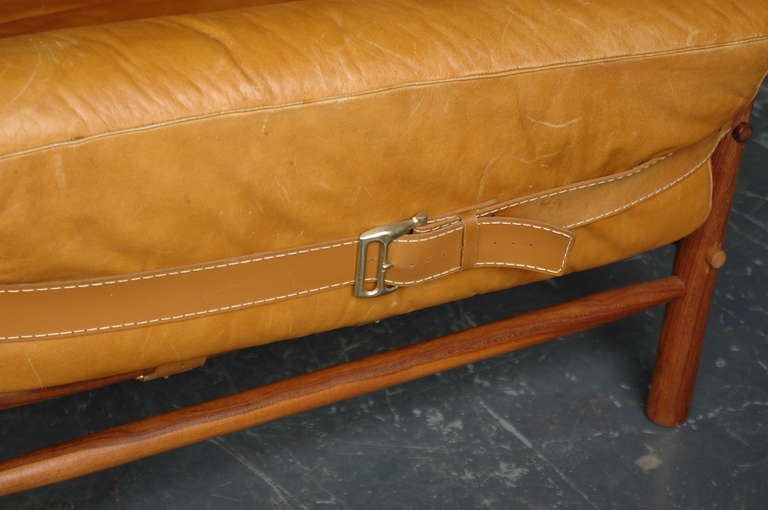 Beautiful sofa in buffalo leather and rosewood frame. The original upholstery has aged beautifully and darkened like an old baseball glove – the effect is amazing! Cushions held by leather straps between frame. All straps intact.