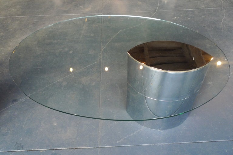 An amazing table with an impossible-seeming cantilevered glass surface and inset steel cap. Polished steel rounded weighted base. Suitable for dining table or desk use. Glass is original and is chipped along the edge, as seen in photographs –