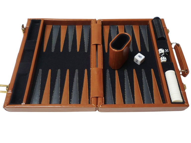 vintage pierre cardin traveling backgammon set in leather case. board is stitched with contrasting leather strips, contains leather dice holder and 15 white and black pieces.

to view our complete inventory catalogue, please visit us at