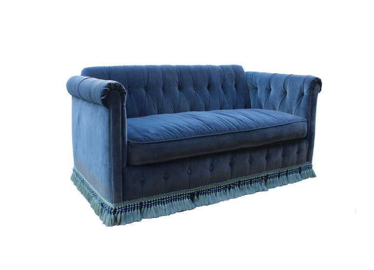 blue velvet button tufted sleeper sofa with fringe trim, a few tassels are missing on this available floor model. priced and available as shown (floor model only)

custom sizing and fabrics available with approximately a 4-6 week lead