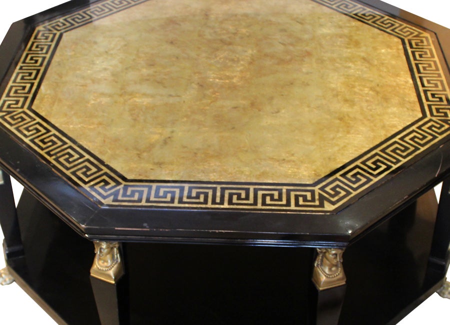 hollywood regency black cocktail table by baker, with greek key border and reverse painted gold leaf top. top is supported by eight female bust columns and claw feet.

to view our complete inventory catalogue, please visit us at www.rummagehome.com