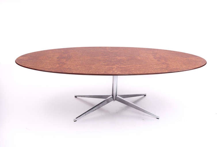 Florence Knoll dining table with typical eliptical foot and an burled walnut top 

Florence Knoll Production. 1st Edition , 1961.