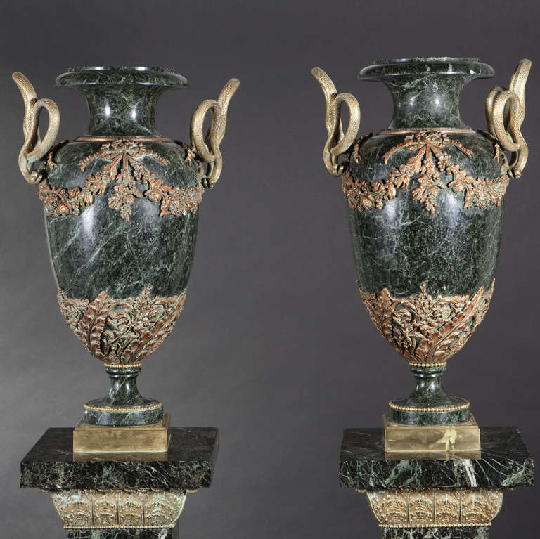 Pair of large marble ornamental vases and their marble pedestals, Louis XVI Style

Pair of large baluster Vert de Mer (sea green) marble ornamental vases with rich chiseled and gilt bronze ornamentations, handles designed as snakes suspending
