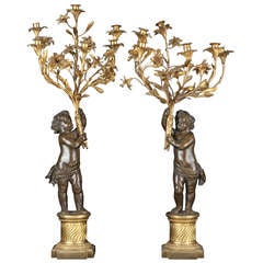 Pair of large patinated and gilt bronze candelabrums, Louis XVI Style