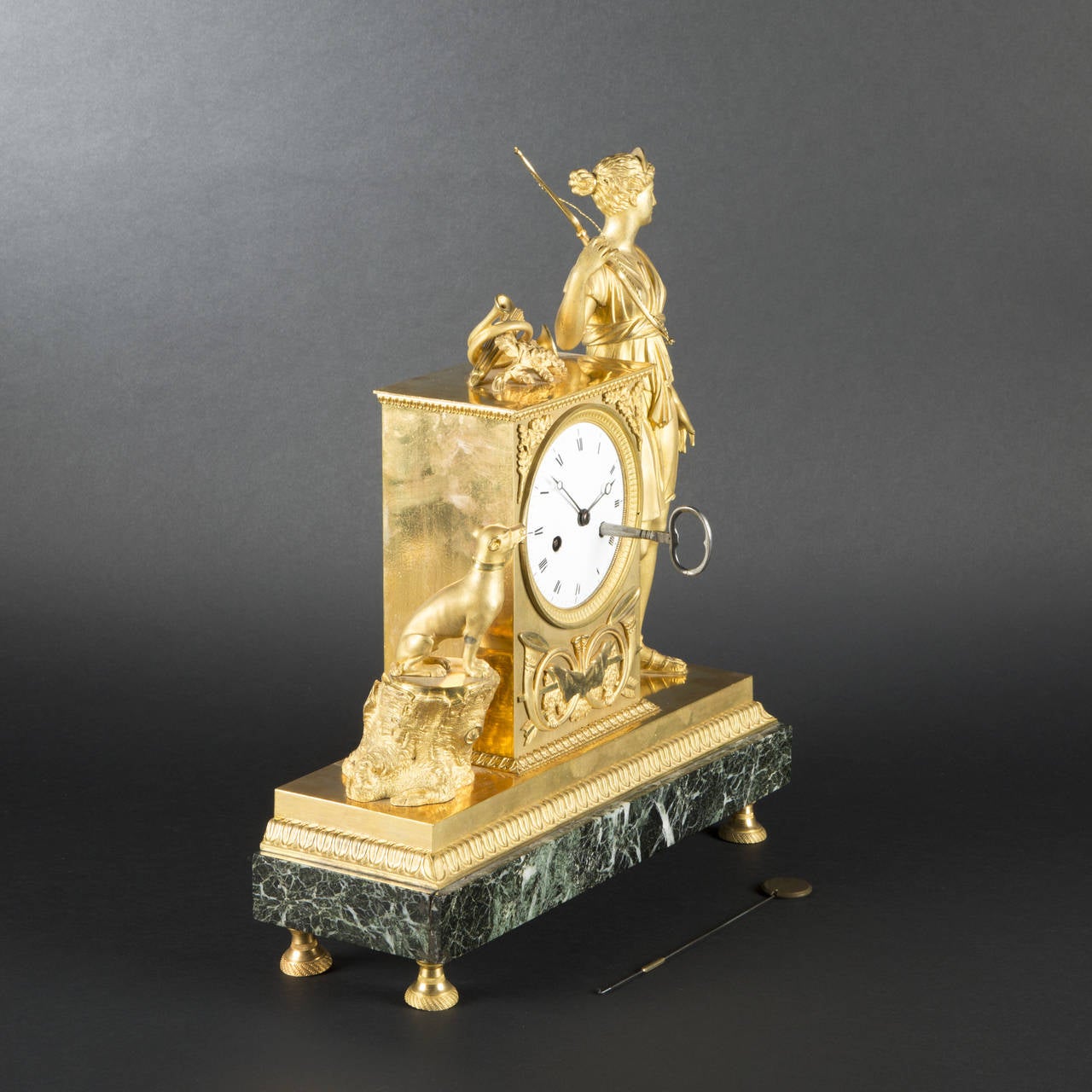 Attributed to Ravrio

Chiseled bronze and gilt mantle clock, in a mercury gilding from the period with burnished agate mat finish, depicting Diana with her attributes, her dog on a tree trunk. Dial-plate on a terminal decorated with hunting horns