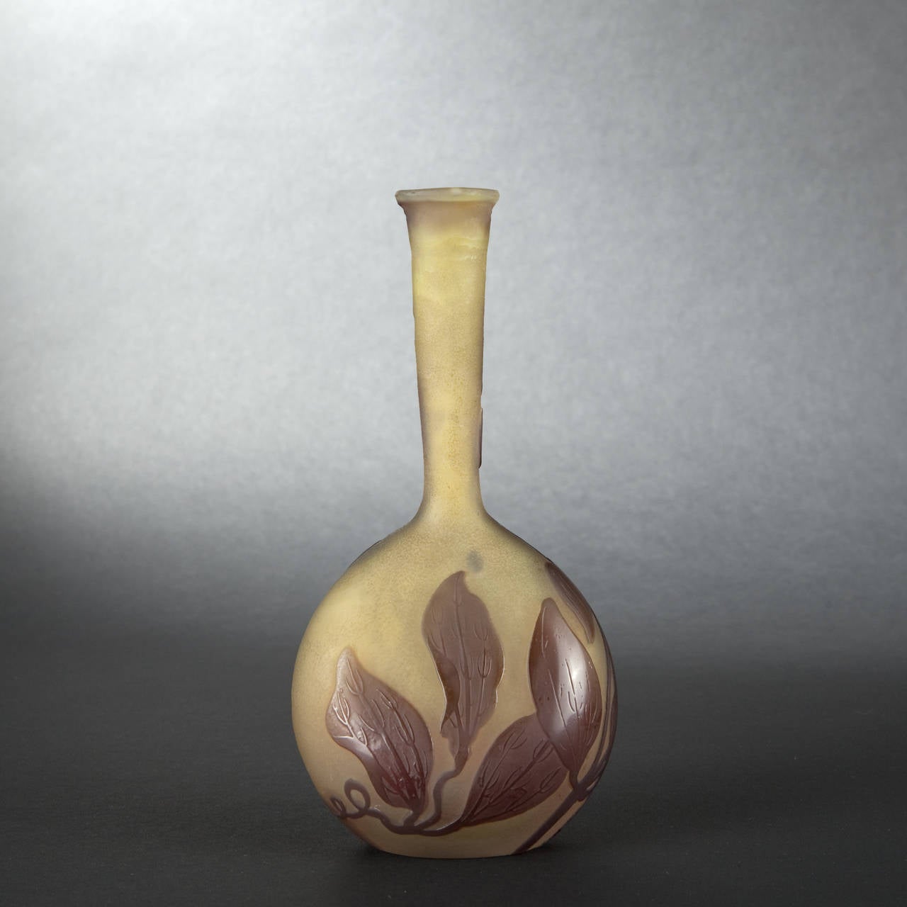 Emile GALLE (1846-1904) 

Soliflore vase with slightly flattened ovoid base. Industrial proof realized in brown glass overlaid against an absinthe-colored ground. Acid-etched iris cameo decoration. Signed. 

Height: 17 cm (6-2/3 in.) - Width : 8