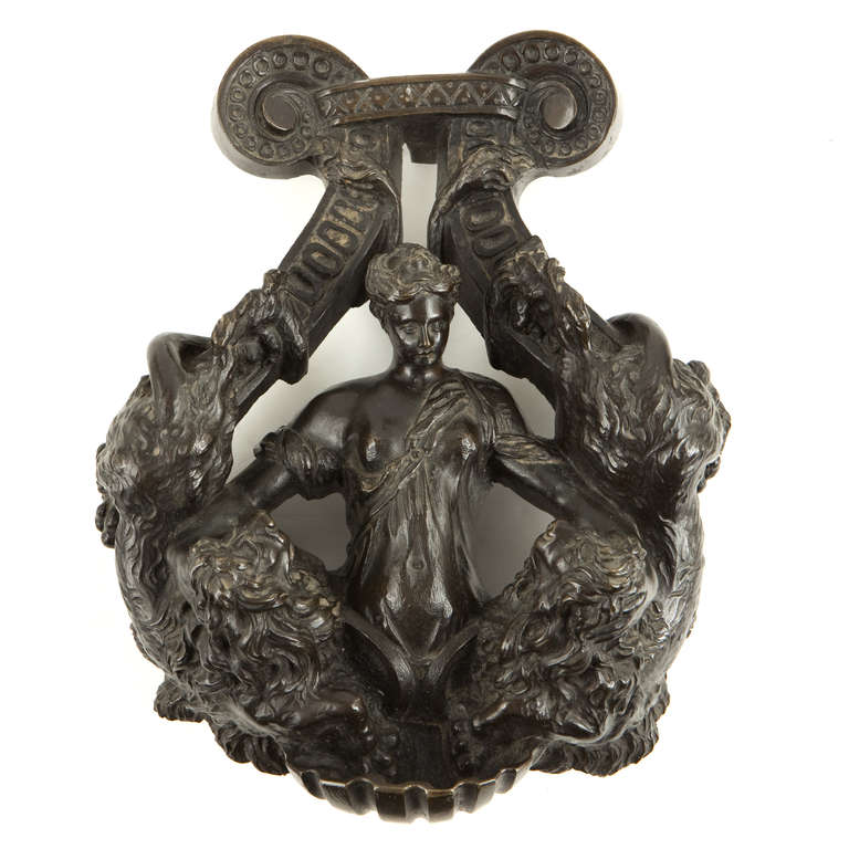 Bronze 16th Century door knocker attributed to Aspetti or Tavagni

Patinated bronze door knocker ornated with one lady holding two lions as strength allegory. Shell grasp.
Height : 29,5 cm (11-1/2 in.) - Width : 22 cm (8-1/2 in.)

The Pierpont