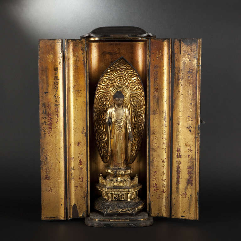 Black and gilt-lacquered butsudan. Japan, 18th Century

Black-lacquered butsudan fitted with two doors and interior with gilt-lacquered Buddha statuette standing atop lotus and in front of mandorla.
Japan, 18th Century
Height of butsudan: 64 cm