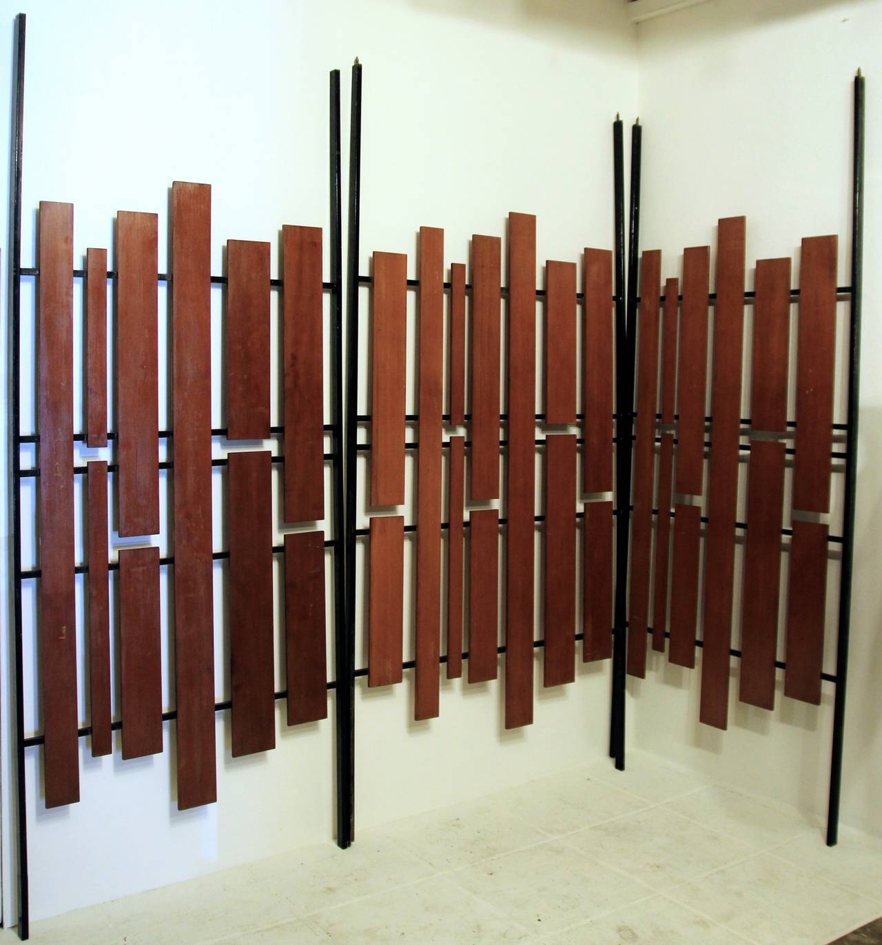 Set of three screens, wood and iron, circa 1960, Italy.
Measurement of panels:
1. Height: 2m78, width: 1M12,
2. Height: 2m78, width: 1M12,
3. Height: 2m78, width: 1.32m.
Total width: 3m56.
Each depth: 4.5 cm.