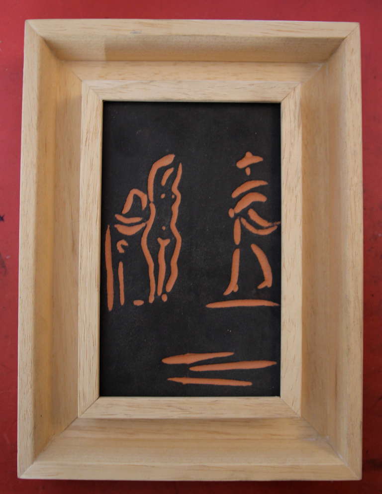 Pablo Picasso (1881-1973) & Atelier Madoura, Femme et Toreador,
Plein Feu/Empreinte originale de Picasso,
Partially glazed terracotta plaque,
Stamped and marked Madoura,
Wooden frame, 
(16,5 x10,2 cm)
Conceived in 1968 and executed in an edition of