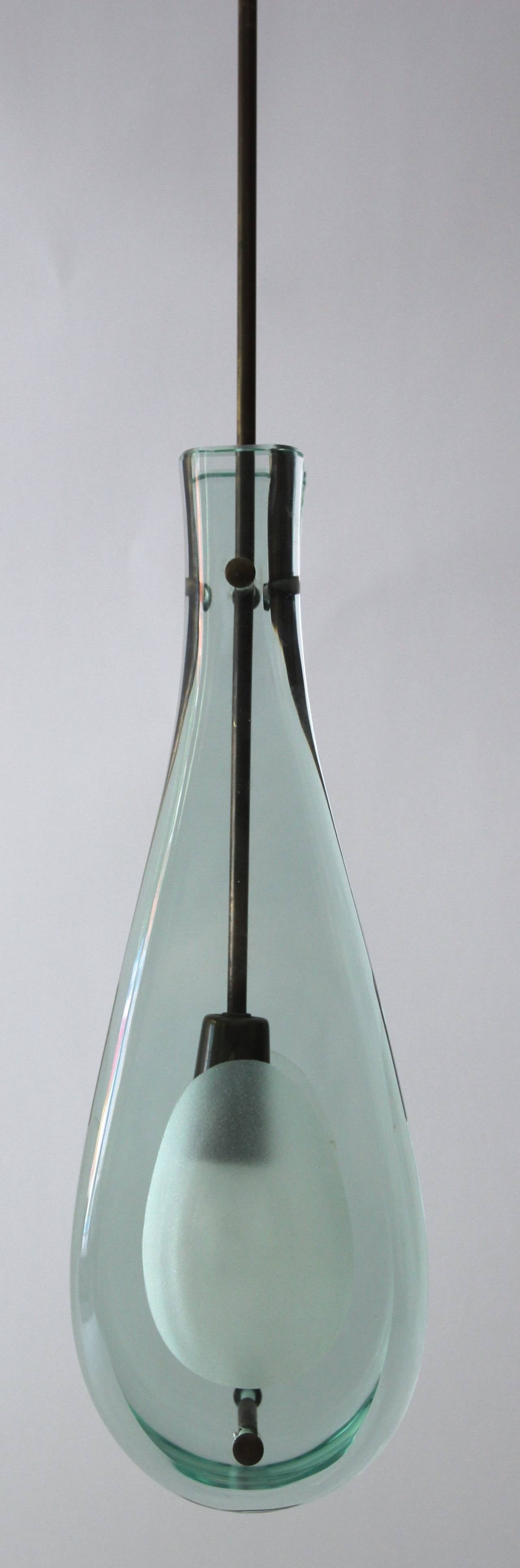 Max Ingrand, 2258 hanging lamp, manufactured by Fontana Arte,
ground shaped crystals with opaque hollows and brass fittings,
Italy, circa 1963.
Measures: Height: 93 cm (36.6in), width: 15 cm, depth: 9 cm.

Biography: similar model, Quaderno di