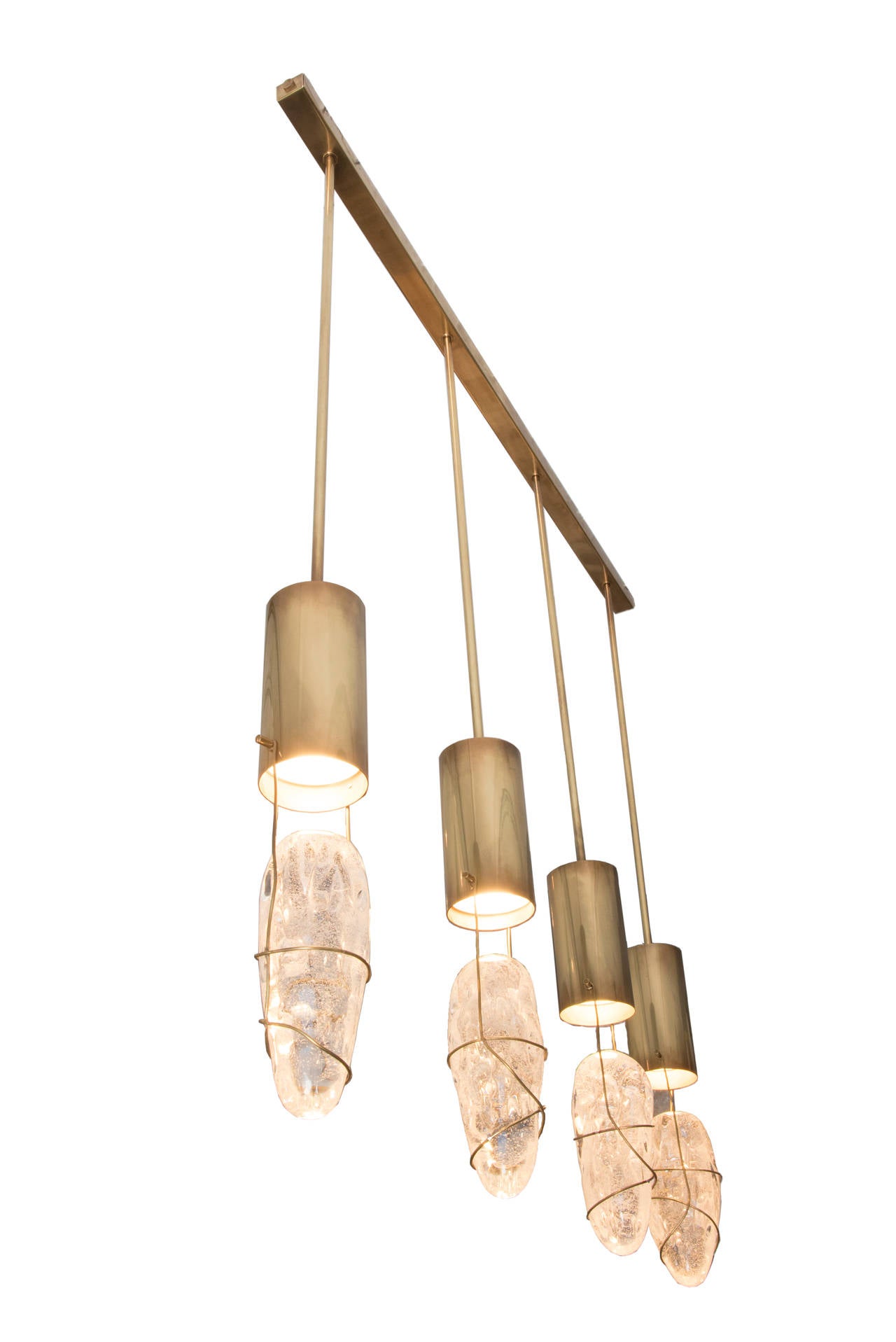 Pendants by Angelo Brotto, four glass lights,
Edition Esperia,
gold brass and glass,
circa 1990, Italy.

Dimensions: Height 130 cm, length 110 cm, diameter of the lamp 11 cm.

Angelo Brotto (1914 - 2002) is an Italian artist and designer recognized