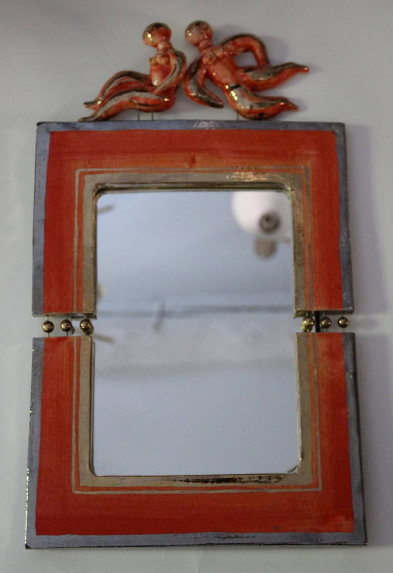 Ceramic Mirror by Georges Pelletier, 
featuring orange and green glaze and dancing figures, France, circa 1960
Signed
Height: 52 cm, length:32 cm, width: 20 cm.

Certificate of authenticity by Georges Pelletier.

Georges Pelletier is a French