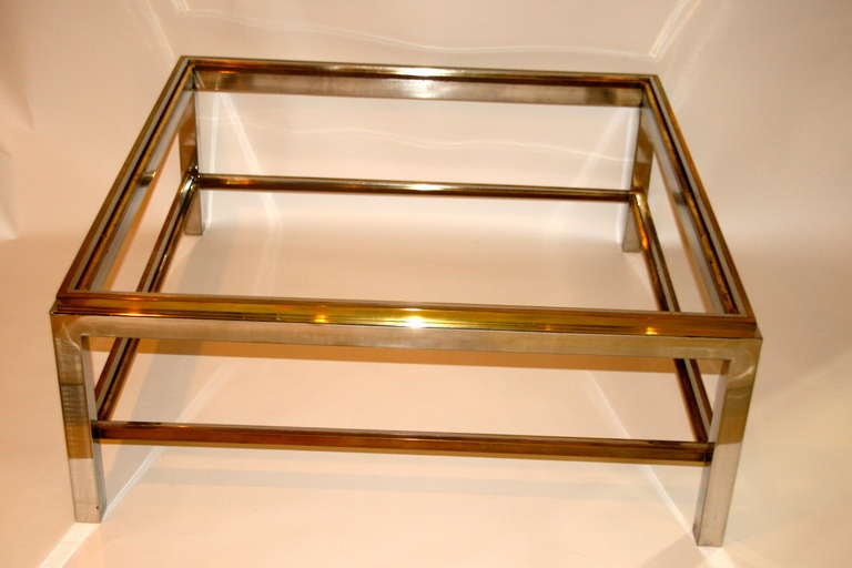 Coffee table, 
Gilt brass and chrome steel ,
Two smoked glass top,
Circa 1970, France.

Measures : Height: 41 cm, glass top: 1mx1m.
(Broken piece of glass in a corner).