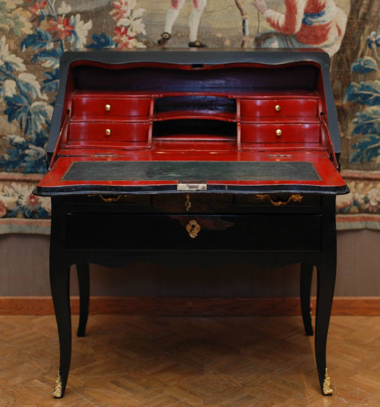 A Louis XV desk opening by an abattant, red lacquer interior, on four cabriole legs, Vernis Martin decorated with flowers and birds in Japanese and Chinese taste.